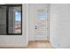 Modern entryway with a glass-paneled door and a large window at 1254 Yates St, Denver, CO 80204