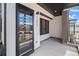 Inviting front porch with a sleek glass door, modern lighting, and address numbers, offering curb appeal at 1254 Yates St, Denver, CO 80204