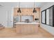 Modern kitchen with stainless steel appliances, a large island, and stylish pendant lighting at 1254 Yates St, Denver, CO 80204