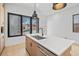 Close-up of a modern kitchen island, stainless steel sink, and a window with a view of the neighborhood at 1254 Yates St, Denver, CO 80204