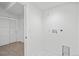 Practical laundry room with white walls, tile flooring, and modern hookups at 1254 Yates St, Denver, CO 80204