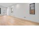Bright and open living room with light wood floors and large windows at 1254 Yates St, Denver, CO 80204