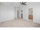 Spacious main bedroom with neutral walls, carpet, and a ceiling fan near the ensuite bathroom and walk-in closet at 1254 Yates St, Denver, CO 80204