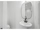 Cozy powder room with modern fixtures and a black-framed mirror at 1254 Yates St, Denver, CO 80204
