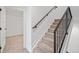 Staircase featuring carpeted steps and a black metal railing at 1254 Yates St, Denver, CO 80204