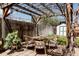 Backyard patio with a wicker table and chairs under a pergola with climbing vines, plus a storage shed at 2841 W 27Th Ave, Denver, CO 80211