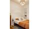 Comfortable bedroom featuring a queen bed, wooden floors, and recessed shelving for optimal storage at 2841 W 27Th Ave, Denver, CO 80211