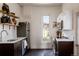 Bright kitchen with stainless steel appliances, a window overlooking the backyard, and dark wood lower cabinets at 2841 W 27Th Ave, Denver, CO 80211