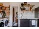 Charming kitchen with open shelves, stainless steel appliances, and a doorway leading to the adjacent laundry room at 2841 W 27Th Ave, Denver, CO 80211