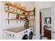 Bright laundry room features open shelving, a butcher block folding counter, and modern LG front loading washer and dryer at 2841 W 27Th Ave, Denver, CO 80211