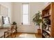 Bright office space features a desk, bookshelf, and a window with natural light, creating a productive environment at 2841 W 27Th Ave, Denver, CO 80211
