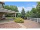 Backyard featuring brick patio, covered deck, mature landscaping and white picket fence at 10961 Gray Cir, Westminster, CO 80020