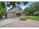An inviting backyard with a brick patio, green grass, mature trees, and a covered outdoor seating area perfect for entertaining at 10961 Gray Cir, Westminster, CO 80020