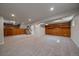 Finished basement showcasing new carpet, recessed lighting and custom wood cabinetry at 10961 Gray Cir, Westminster, CO 80020