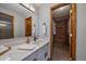 Modern bathroom featuring a quartz countertop, framed mirror and custom wood closet at 10961 Gray Cir, Westminster, CO 80020