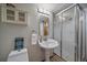 Bathroom featuring pedestal sink, frameless glass enclosed shower and decorative wall art at 10961 Gray Cir, Westminster, CO 80020
