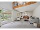 Open-concept living room with sliding glass doors, comfortable seating, and lofted area at 10961 Gray Cir, Westminster, CO 80020