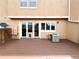 Wooden deck with glass patio doors and modern AC unit on an outside wall at 13187 E Bethany Pl, Aurora, CO 80014