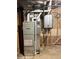 Exposed basement utilities including furnace, water heater, and pipes at 13187 E Bethany Pl, Aurora, CO 80014
