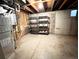 Unfinished basement space with open ceilings, concrete floor, and basic shelving at 13187 E Bethany Pl, Aurora, CO 80014