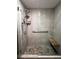 Walk in shower with a shower bench and handheld shower head at 13187 E Bethany Pl, Aurora, CO 80014