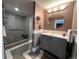 Updated bathroom featuring a shower, vanity and decorative mirror at 13187 E Bethany Pl, Aurora, CO 80014