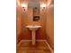Small bathroom with pedestal sink, mirror, and lighting fixtures at 13187 E Bethany Pl, Aurora, CO 80014