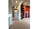 View of the hallway with carpet, laundry area, and built in shelves at 13187 E Bethany Pl, Aurora, CO 80014