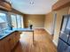 View from kitchen to dining area with breakfast bar and french door access to the outside at 13187 E Bethany Pl, Aurora, CO 80014