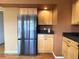 Kitchen area with stainless steel refrigerator and light wood cabinets at 13187 E Bethany Pl, Aurora, CO 80014
