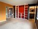 Living room featuring built in shelves, and access to the bathroom at 13187 E Bethany Pl, Aurora, CO 80014