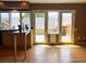 Sunlit living area with hardwood floors, French doors leading to outdoor patio, adjacent to the kitchen at 13187 E Bethany Pl, Aurora, CO 80014