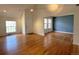 Spacious living room featuring gleaming hardwood floors, neutral paint, and ample natural light at 13187 E Bethany Pl, Aurora, CO 80014