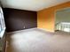 Spacious living room with brown and orange walls and carpet at 13187 E Bethany Pl, Aurora, CO 80014