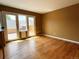 Bright living room with hardwood floors and French doors leading to the outdoor patio at 13187 E Bethany Pl, Aurora, CO 80014