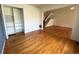 Inviting living room features hardwood floors, closet with shelving, and staircase to the upper level at 13187 E Bethany Pl, Aurora, CO 80014