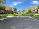 Visitor parking area with lush landscaping and trees in a well-maintained community at 13187 E Bethany Pl, Aurora, CO 80014