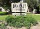 Community sign for Dam East Townhomes, surrounded by greenery and shrubbery at 13187 E Bethany Pl, Aurora, CO 80014