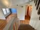 Staircase leading down to a living room with hardwood floors and a blue accent wall at 13187 E Bethany Pl, Aurora, CO 80014