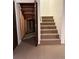 Basement stairway with wooden support beams under stairs, carpeted steps at 13187 E Bethany Pl, Aurora, CO 80014