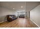 Finished basement with wood-look floors and comfortable seating at 11811 E Maplewood Ave, Englewood, CO 80111