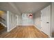 Open basement space with wood-look tile flooring and stylish lighting at 11811 E Maplewood Ave, Englewood, CO 80111