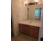Neutral bathroom with tile floor, vanity and mirror at 11811 E Maplewood Ave, Englewood, CO 80111