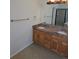 Bathroom featuring a double sink vanity with granite countertop and warm lighting at 11811 E Maplewood Ave, Englewood, CO 80111