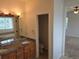 Bathroom featuring a double sink vanity with granite countertop and warm lighting at 11811 E Maplewood Ave, Englewood, CO 80111
