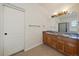 Bathroom with double sinks, a large mirror and storage at 11811 E Maplewood Ave, Englewood, CO 80111