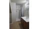 Bathroom features a tiled walk-in shower with a decorative, marble-like accent at 11811 E Maplewood Ave, Englewood, CO 80111
