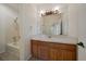 Bathroom with a large mirror, oak cabinets, and a combined tub and shower at 11811 E Maplewood Ave, Englewood, CO 80111