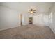 Spacious bedroom features neutral paint, ceiling fan and plush carpeting at 11811 E Maplewood Ave, Englewood, CO 80111