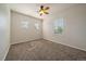 Carpeted bedroom featuring a ceiling fan and three windows providing natural light at 11811 E Maplewood Ave, Englewood, CO 80111